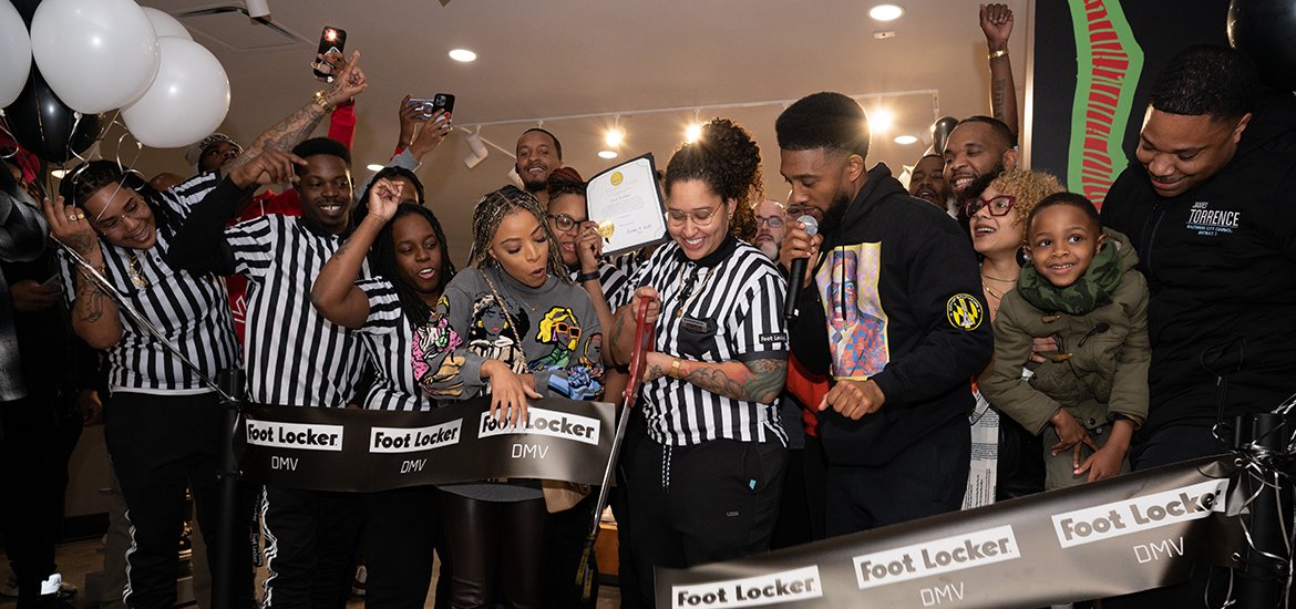 Mayor Scott takes a photo with the Foot Locker team at the Grand Opening of the new Mondawmin Mall location